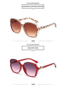 Detailed side view of tortoise and red square sunglasses with gold metal hinges