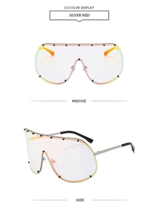 Detail of silver oversized shield sunglasses with red-yellow gradient lenses and black studs