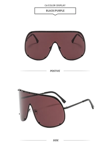 Detail view of oversized shield sunglasses with studded frame and dark purple lenses