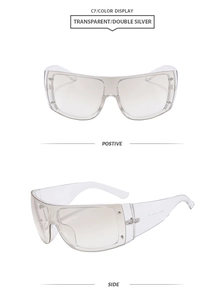 Detail of transparent oversized shield sunglasses with metal rivet accents and silver lenses