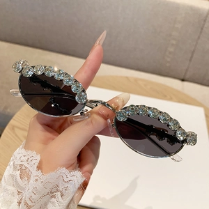 Oval rhinestone sunglasses with dark lenses and slim metal temples for trendy women
