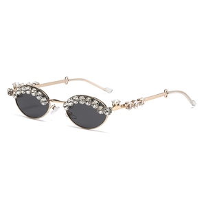 Oval vintage sunglasses with gold frame and crystals shown from a 45-degree angle