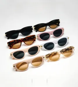Detail view of retro cat eye sunglasses in multiple colors with gold metal temple accents