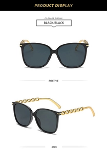 Detail view of square black sunglasses featuring elegant gold metal chain temple accents