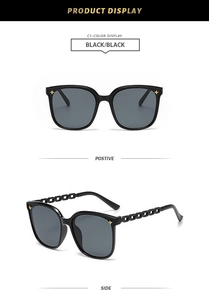 Detail of black square sunglasses with gold star studs and hollow chain temples