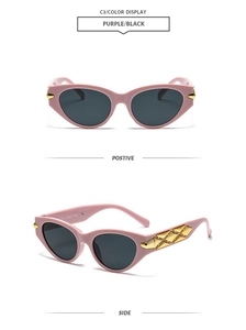 Detail view of pink cat-eye sunglasses with golden geometric temple metal accents