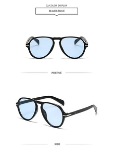 Detail of pilot sunglasses with blue lenses and silver arrow hinge decoration
