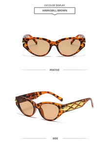 Detail view of tortoiseshell cat-eye sunglasses with gold cross-grid temple accents