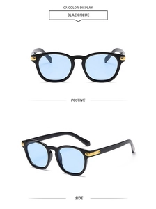 Detail of square vintage sunglasses with blue lenses and gold decorative temple hinges