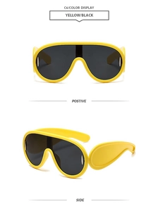 Detailed view of yellow oversized sunglasses with wide temples and dark lenses