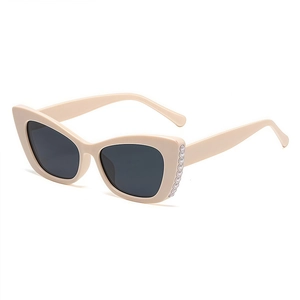 Chic beige cat-eye sunglasses with pearl embellishments and dark lenses for women