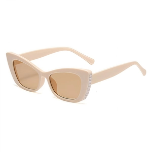 Chic cream cat-eye sunglasses with pearl bead detailing and dark brown lenses