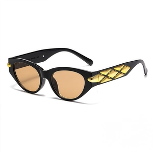 Retro cat-eye sunglasses with black frame, amber lenses, and gold geometric temple details