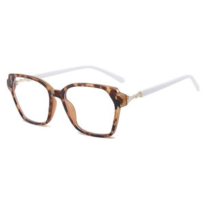 Lunettes carrées à monture léopard et branches blanches, vue à 45 degrés sur fond blanc
