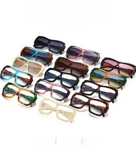 Flat lay collection of oversized square sunglasses in assorted frame colors and patterns