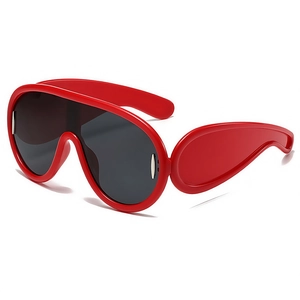 Fashionable oversized bright red shield sunglasses with futuristic black lenses