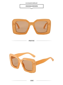 Detail of orange translucent square sunglasses with brown lenses and chunky retro frames