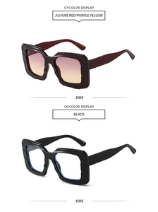 Detail view of oversized geometric sunglasses in jujube red and classic black finishes