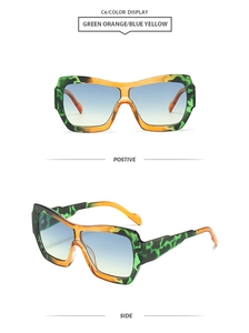 Detail view of green orange camouflage oversized sunglasses with blue yellow gradient lenses