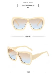 Detail view of oversized square sunglasses with beige frames and tea-blue gradient lenses