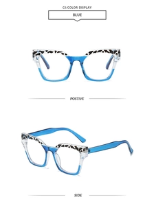 Detail view of square blue frame glasses with cow print accents and clear lenses