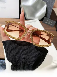 Macro detail of luxury gold-rimmed sunglasses with pavé rhinestones and gradient lenses
