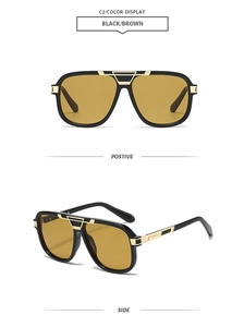 Close-up of retro square sunglasses with black frame, brown lenses and gold metal details