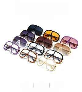 Multiple colors of oversized sunglasses with metallic hinge details in a neat grid array