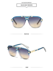 Detail of blue aviator sunglasses with gold metal bridge and purple gradient lenses