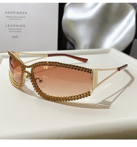 Detailed macro view of luxury cat-eye sunglasses with gold rhinestone frames and tinted lenses