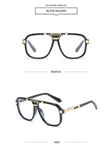 Detail of black square sunglasses with decorative golden metal cutouts and temple accents