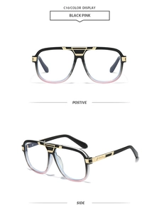 Detail of square glasses with black pink gradient frame and gold metal accents