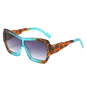 Retro oversized square sunglasses featuring tortoiseshell and teal frames with purple lenses