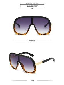 Detail of oversized leopard frame sunglasses with gradient grey lenses and gold accents