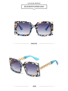Detail of blue bean flower square sunglasses with golden chain temples and gradient lenses