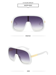 Detail of white oversized sunglasses with gradient purple lenses and gold metal accents