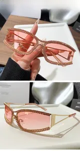 Detailed macro view of pink cat eye sunglasses with rhinestones and gold metal frame