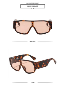Vue détaillée de grandes lunettes de soleil en écaille avec verres orange translucides