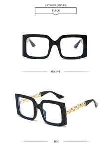 Detail of square vintage sunglasses with gold metal chain arms and blue light filter