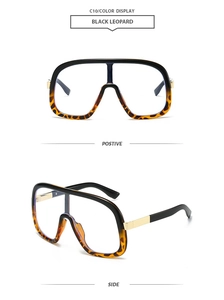 Detail view of large frame sunglasses in black leopard finish with gold metal temples