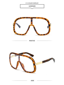 Detail of oversized leopard print sunglasses featuring stylish golden metal temples