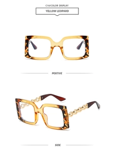 Detail view of yellow leopard square sunglasses with gold metal chain decorative temples