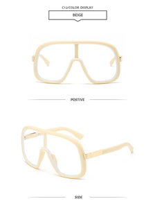 Detail view of beige oversized sunglasses frame with polished golden metal hinges