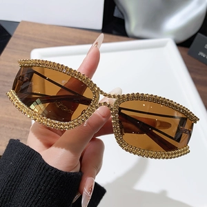 Luxury oversized cat eye sunglasses with gold frames and sparkling amber rhinestones