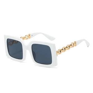 Fashionable oversized square sunglasses with cream frame and gold chain temples