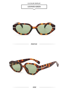 Detail of leopard print sunglasses with green lenses and silver metal temple accents