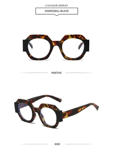 Detail view of tortoiseshell polygon sunglasses with bold black contrast trim