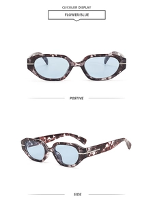 Detail view of flower patterned frames and light blue lenses of these retro sunglasses