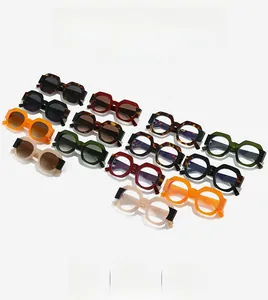 Detail view of geometric hexagonal sunglasses in various colors on a white background