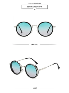 Detail view of round retro sunglasses with black frames and green-pink gradient lenses